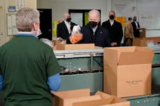 Bidens pack carrots, apples into boxes during food bank stop
