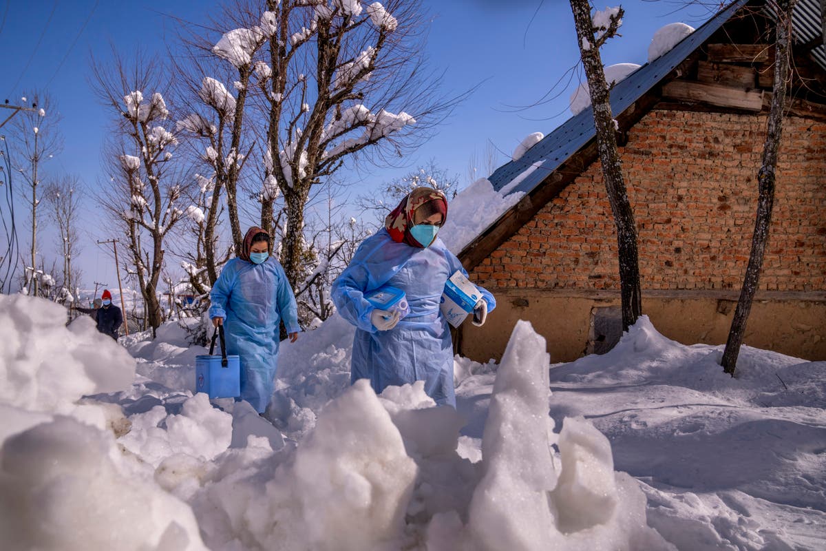 AP Photos: Vaccine workers trek in Kashmir's snowy mountains