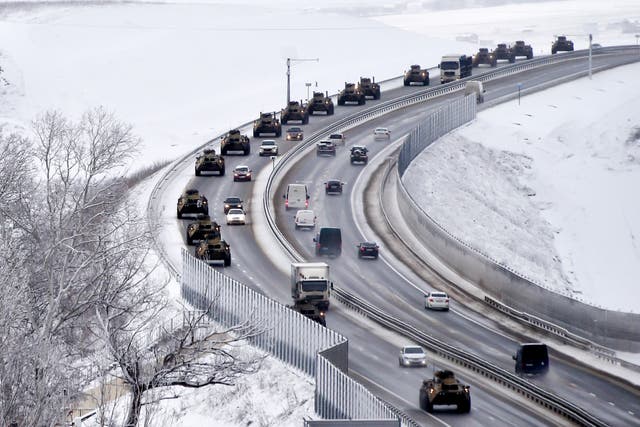 A convoy of Russian armored vehicles moves along a highway in Crimea