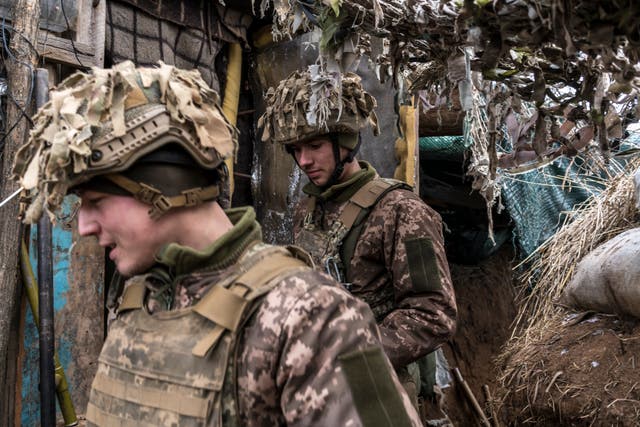 Ukrainian soldiers walk in a trench near the front line in the village of New York, formerly known as Novhorodske, Ukraine