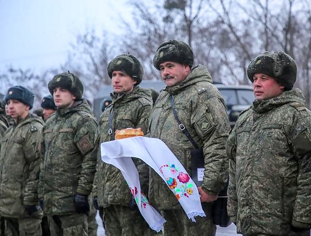 Russian servicemen holding a traditional Belarus’ bread and salt upon their arrival for the joint drills in Belarus