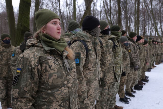 Civilians, including Tatiana (L), 21, a university veterinary medicine student who is also enrolled in a military reserve program, participate in a Kyiv Territorial Defence unit training on a Saturday in a forest in Kyiv, Ukraina
