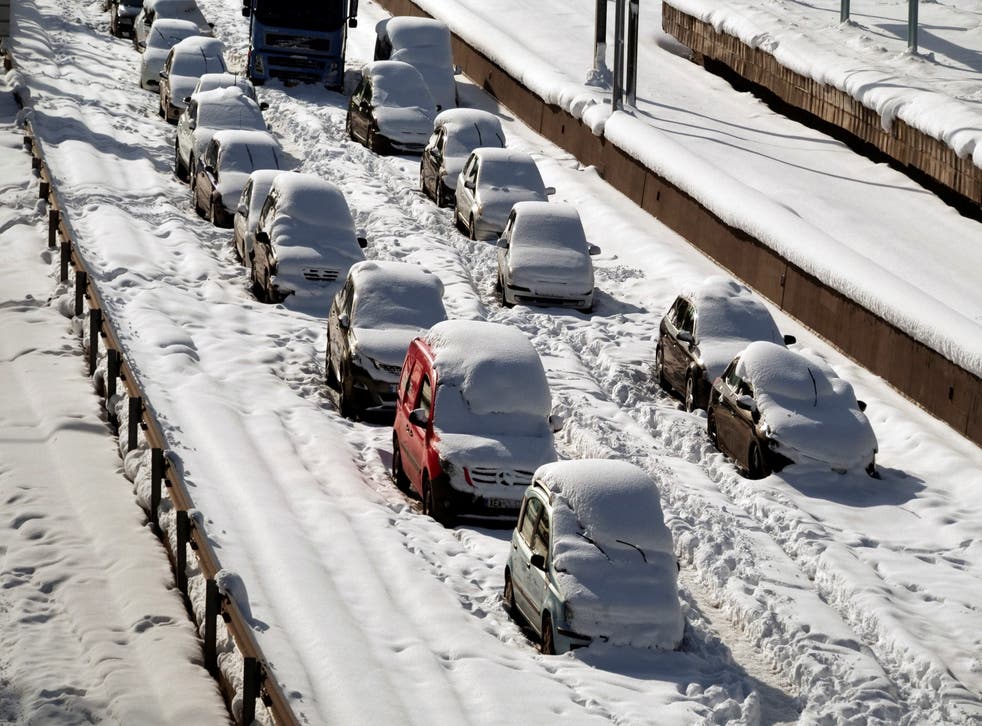 <p>Abandoned vehicles are covered in snow, following heavy snowfall in Athens</p>