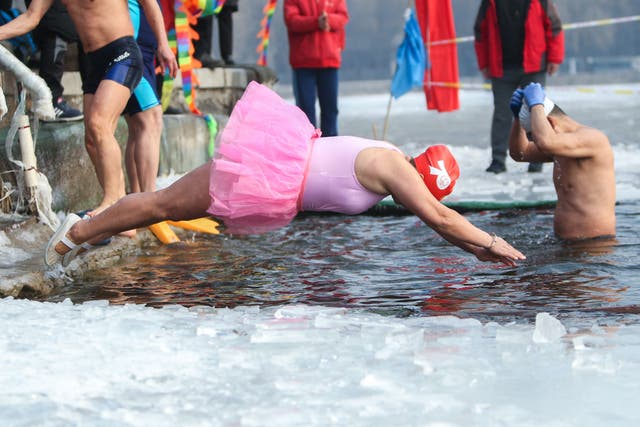 A winter swimming enthusiast dives into a partly frozen lake in a partly frozen lake in Shenyang, in northeastern China’s Liaoning province