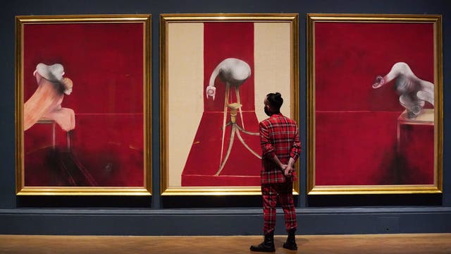A member of staff looks at Francis Bacon’s work ‘Second Version of Triptych 1944’ on display in the Francis Bacon: Man and Beast exhibition at the the Royal Academy of Arts in London