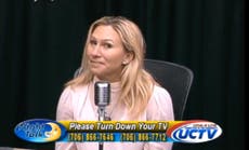 Taylor Greene smiles awkwardly as TV show caller says she is ‘an embarrassment’