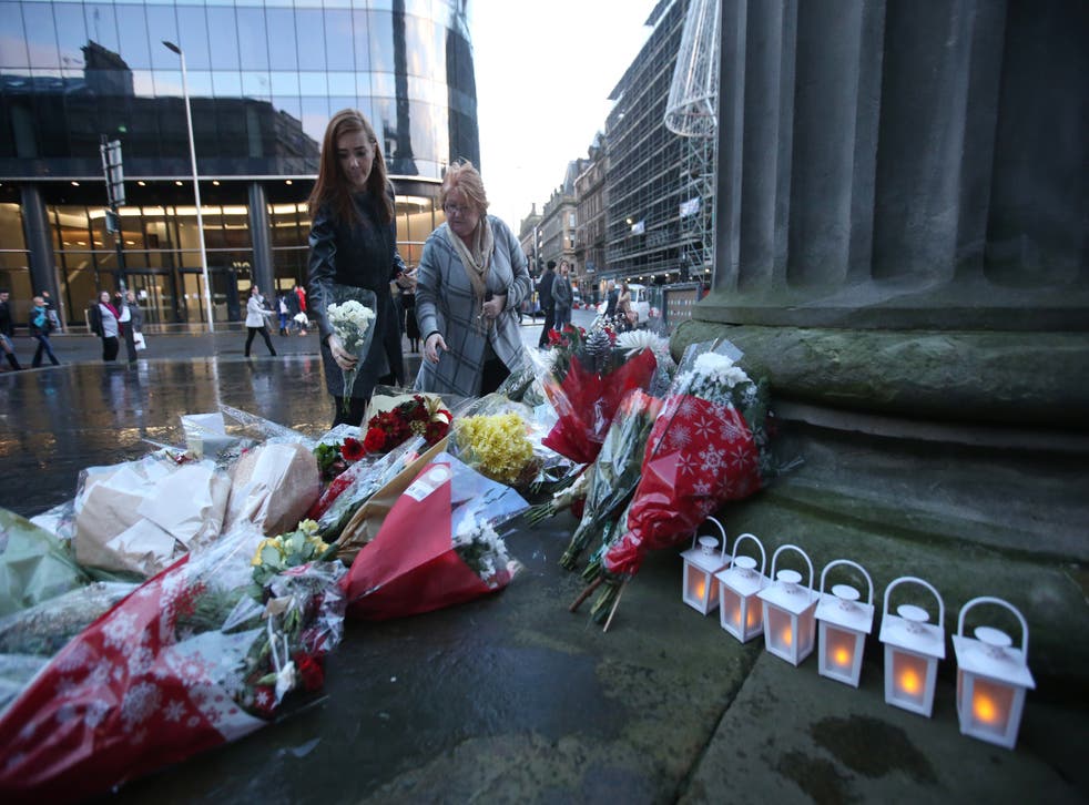 Flowers and tributes left in Royal Exchange Square dedicated to those who were killed in the Glasgow bin lorry crash (Andrew Milligan/PA)