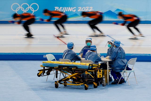 Le personnel médical en équipement de protection individuelle est vu lors d'une séance d'entraînement de patinage de vitesse pour le Pékin 2022 Jeux olympiques d'hiver