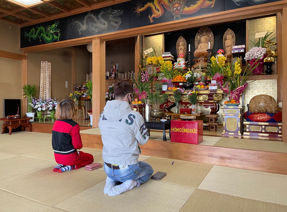 <p>Visitors pray at Daionji, a temple in Honjo, in Saitama prefecture</p>