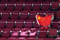 AP PHOTOS: Olympic fans undaunted by closed Winter Games