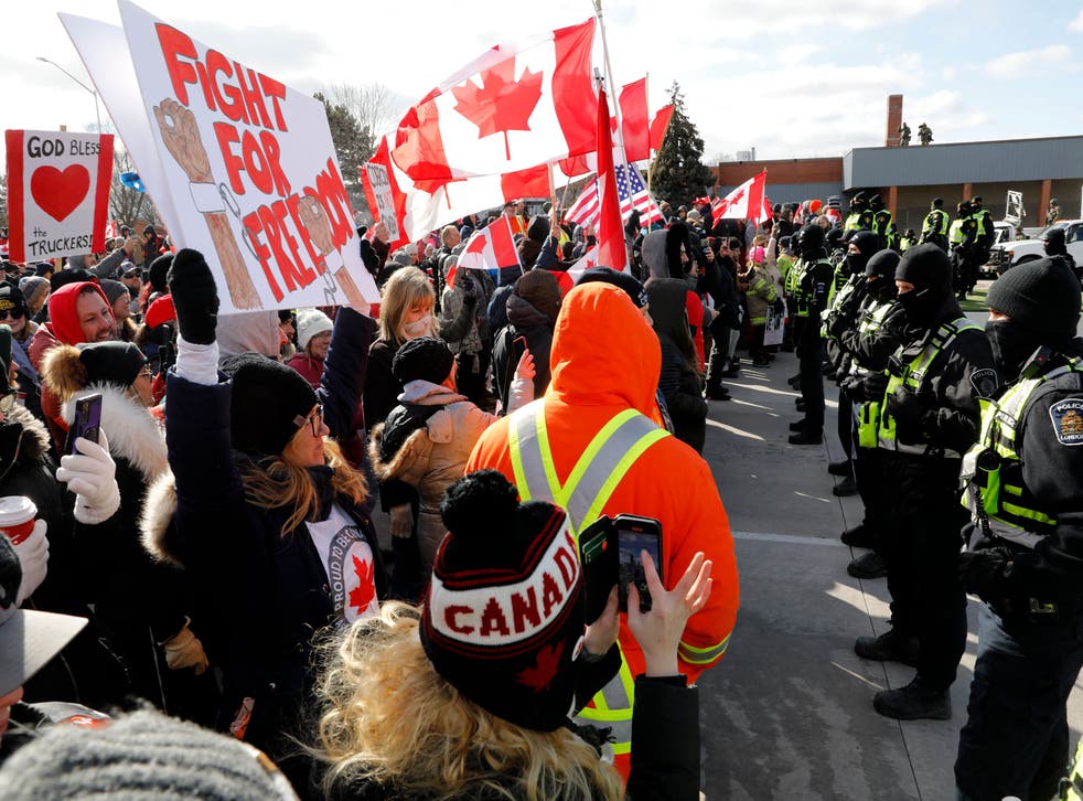 <p>Protestors confront Ontario police as they try to clear the Ambassador Bridge between the US and Canada</bl>