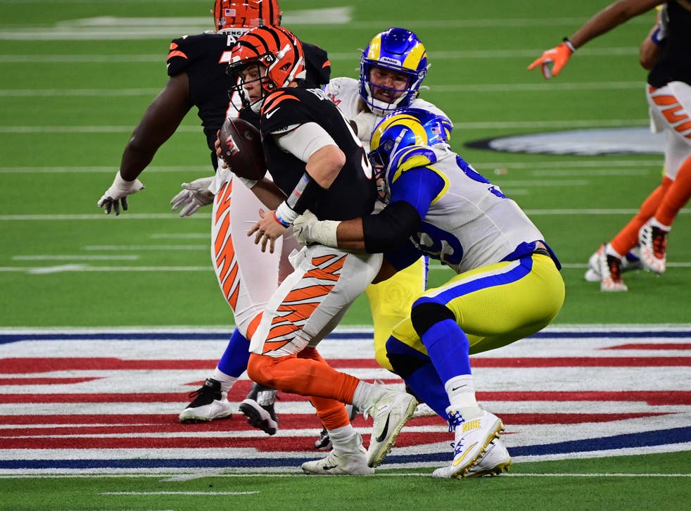 <p>Los Angeles Rams defensive tackle Aaron Donald wraps up Cincinnati Bengals quarterback Joe Burrow</s>