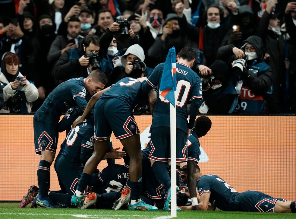 <p>Kylian Mbappe is mobbed by his Paris St Germain team-mates after his stoppage-time winner (Thibault Camus/AP)</p>