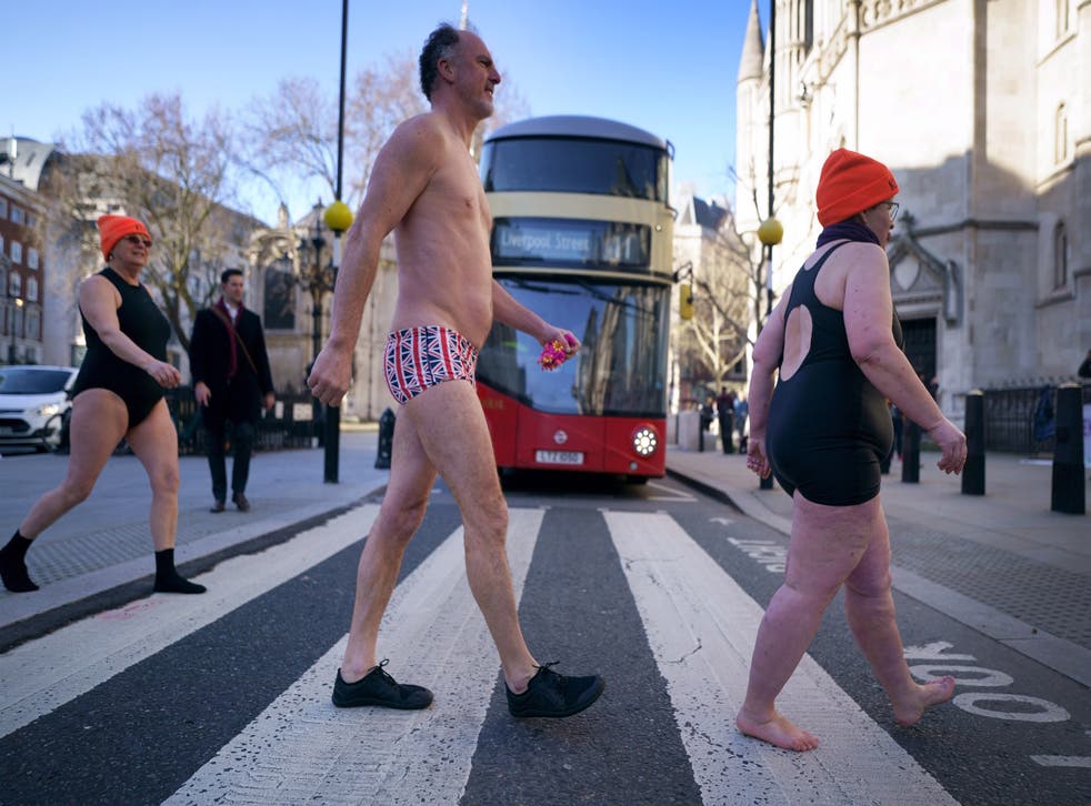 Swimmers from Hampstead Ponds make their way to the Royal Courts of Justice in London (Victoria Jones/PA)
