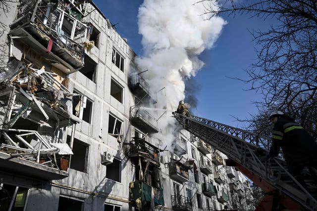 Firefighters work on a building after bombings on the eastern Ukraine town of Chuguiv. Russian armed forces are trying to invade Ukraine from several directions, using rocket systems and helicopters to attack Ukrainian position in the south, the border guard service said