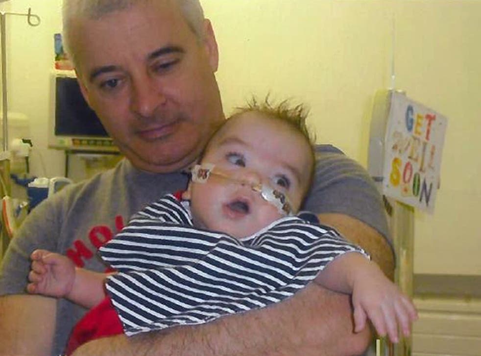 Kevin McGuigan, who was shot to death three months after Mr Davison’s dead, with his grandson Ollie in happier times (PSNI/PA)
