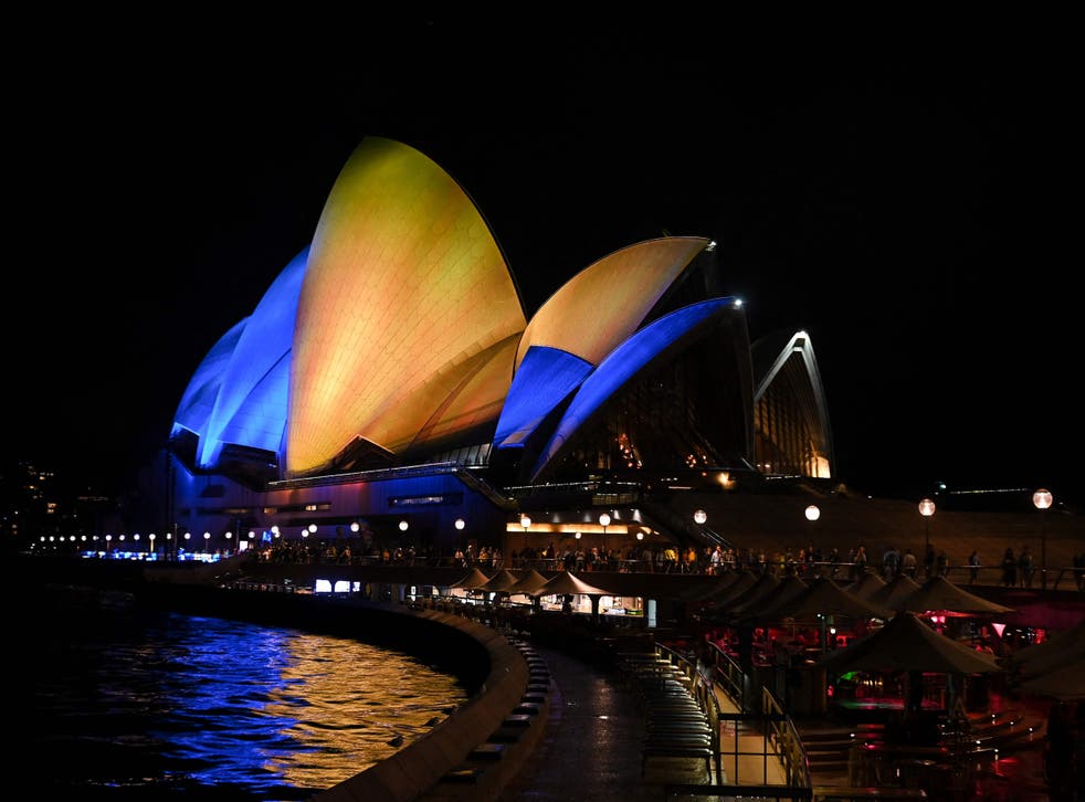<p>The sails of the Sydney Opera House are illuminated with the colours of the Ukrainian flag</p>
