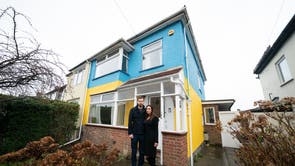 Rend Platings and her husband Michael outside their home in Cambridge, which they have painted in the colours of the Ukraine flag in a show of support for friends in the country