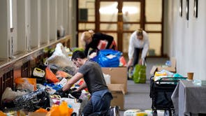 Volunteers help sort through fresh donations after more than 500 boxes of essential supplies were gathered by Parenting Network at Portsmouth Guildhall