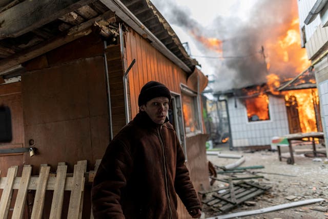 A local resident reacts as a house is on fire after heavy shelling on the only escape route used by locals to leave the town of Irpin, while Russian troops advance towards the capital, 24km from Kyiv, Ukraina