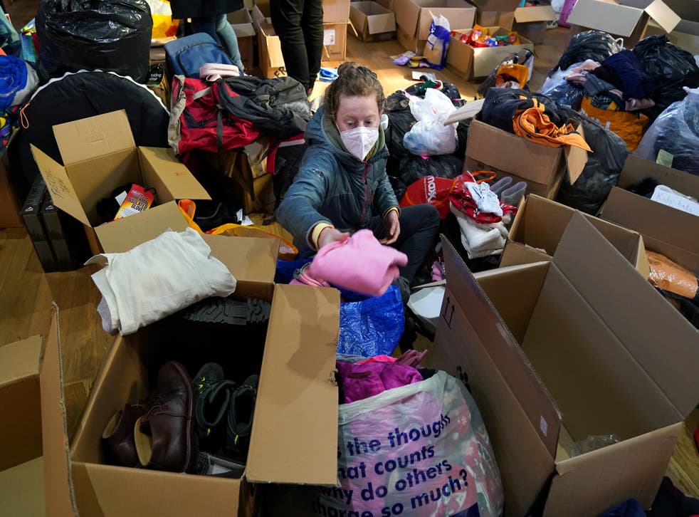 Volunteers from Rain or Shine, South Lanarkshire check through donations bound for Ukraine at Old Trinity Church in Cambuslang (Andrew Milligan/PA)