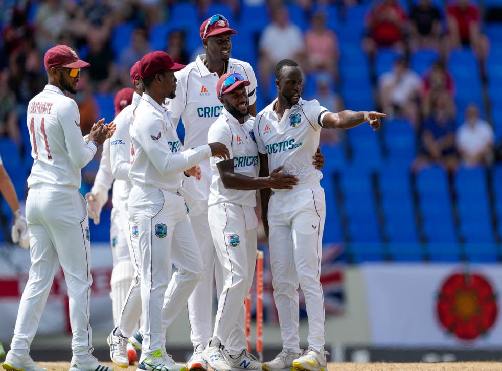 Kemar Roach, Ikke sant, celebrates the wicket of England captain Joe Root (Ricardo Mazalan/AP)