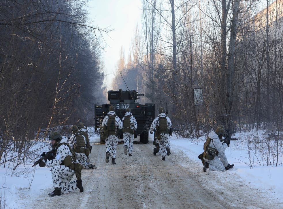 <p>Ukrainian armed forces simulate a crisis situation in an urban settlement in the abandoned city of Pripyat near the Chernobyl plant in the weeks before the Russian invasion</p>