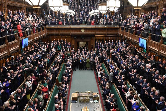 MPs giving a standing ovation to Ukraine's President Volodymyr Zelensky after he speaks to them by live video-link in the House of Commons, i London