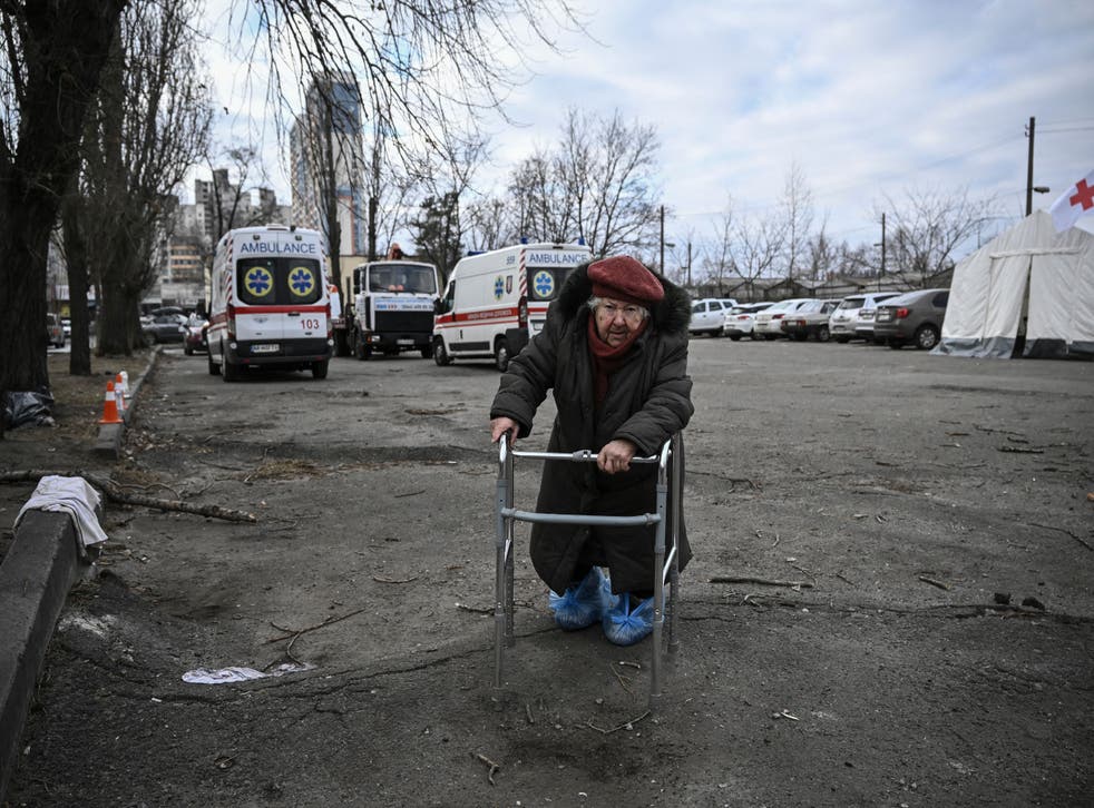 <p>An elderly woman leans on her walker as she stands outside a destroyed apartment building following shelling in the northwestern Obolon district of Kyiv</p>