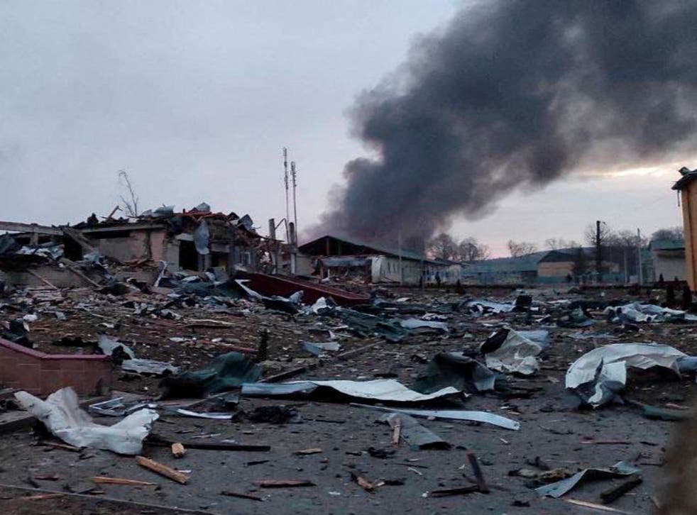 <p>Smoke rises amid damaged buildings following an attack on the Yavoriv military base</p>