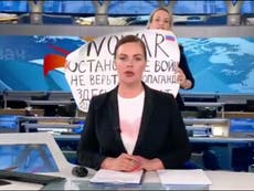 Protester breaks into Russian evening newscast with anti-war sign