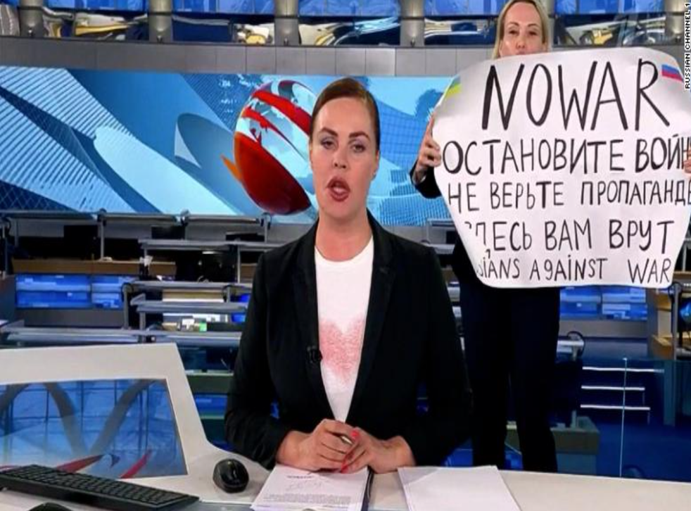 <p>Marina Ovsyannikova is seen holding up her anti-war sign on Russian TV </p>