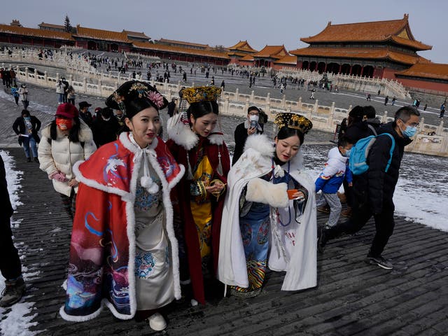 Visitors dressed in period costumes walk near the Gate of Supreme Harmony in the Forbidden City in Beijing