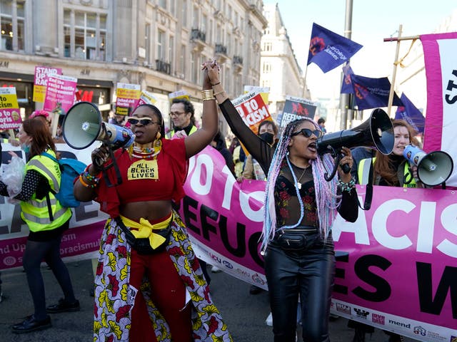People take part in the “Stand up to Racism” march in central London to mark UN Anti-Racism Day