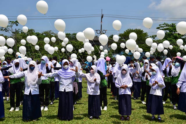 Students hold white balloons during a demonstration against violence, after recent incidents between Thai rangers and suspected separatists, in Ra-ngae district in the southern Thai province of Narathiwat