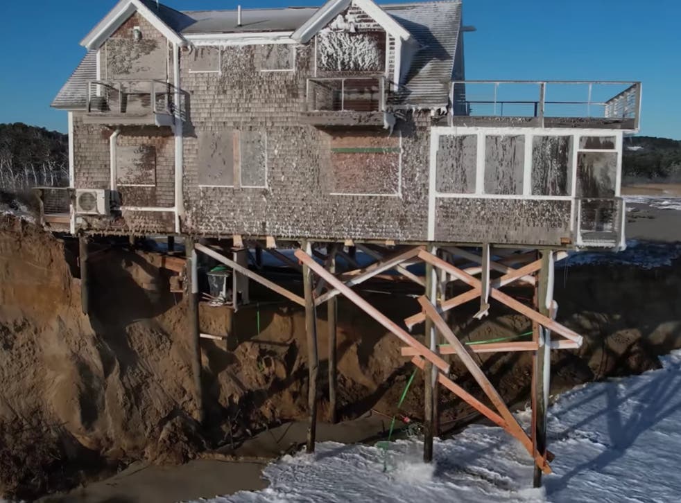 <p>A home on Ballston Beach on Cape Cod was left teetering over the ocean following a severe storm known as a ‘bomb cyclone’ in January</p>