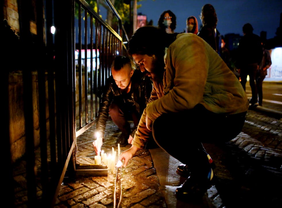Fans of US band Foo Fighters place lights in front of the hotel where the band’s drummer Taylor Hawkins was found dead in Bogota, Colombia (Leonardo Munoz/AP)
