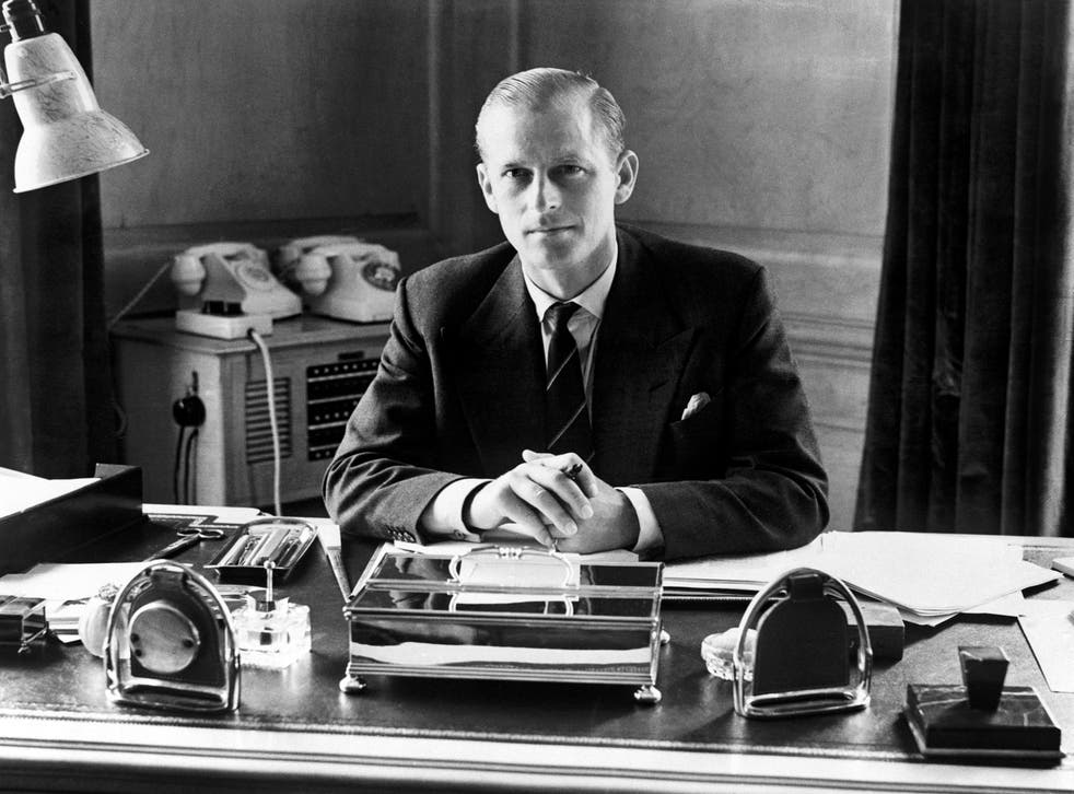 Philip working at his desk as a young man (PA)