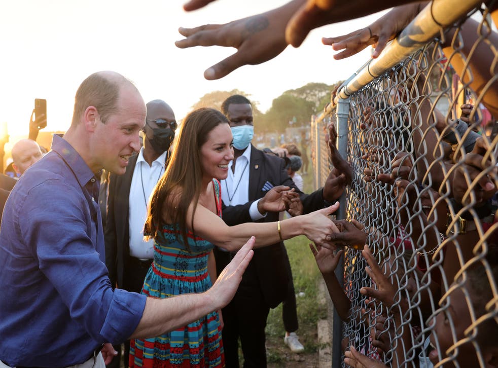 <p>The Duke and Duchess of Cambridge were widely criticsed over this photo, as they shake hands with children behind fences during a visit to Trench Town  </p>