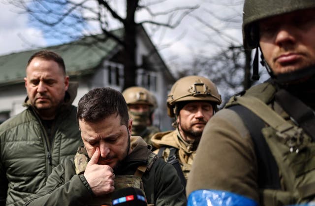 Volodymyr Zelensky (2nd L) walks in the town of Bucha, just northwest of Kyiv, after reports that hundreds of civilians were killed