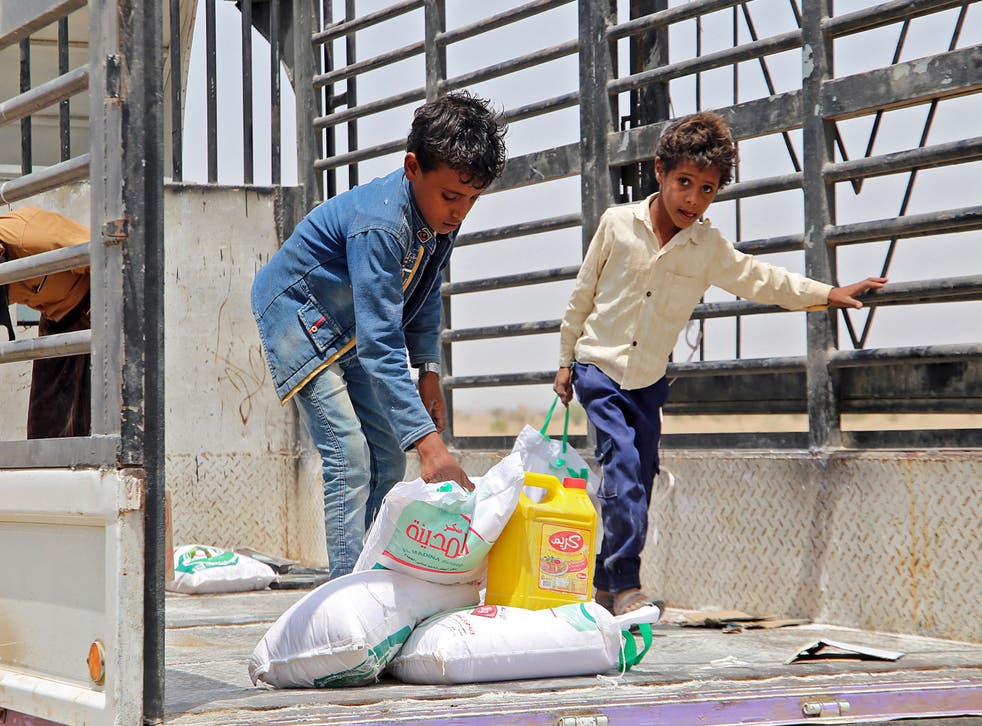 <p>Displaced children receive food aid at a camp in the Hodeidah province of Yemen </s>