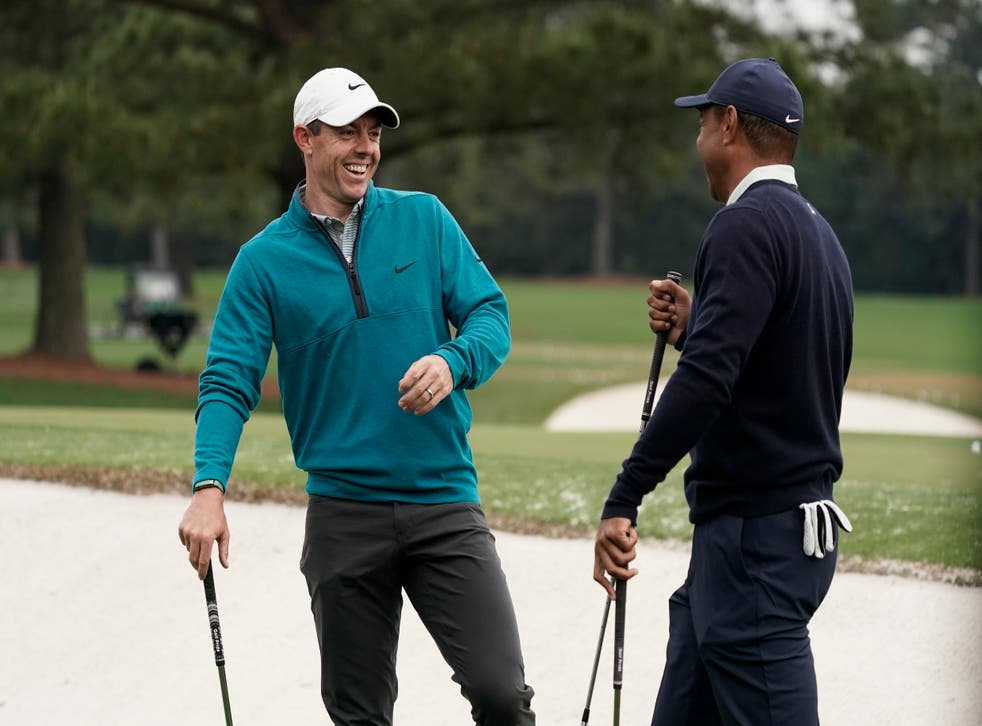 Tiger Woods is greeted by Rory McIlroy during practice ahead of the 86th Masters (Charlie Riedel/AP)