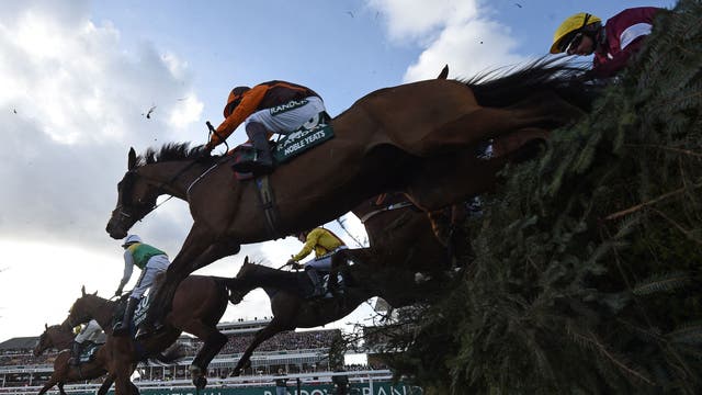 Eventual winner Noble Yeats ridden by jockey Sam Waley-Cohen take the water-jump during the Grand National Steeple Chase on the final day of the Grand National at Aintree Racecourse in Liverpoo
