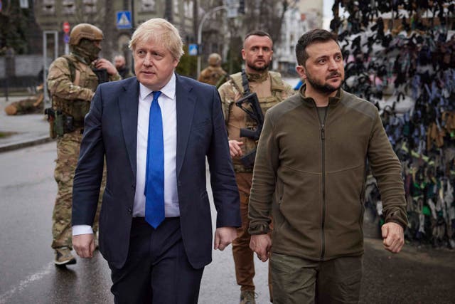 Volodymyr Zelensky and Boris Johnson walk during their meeting in downtown Kyiv