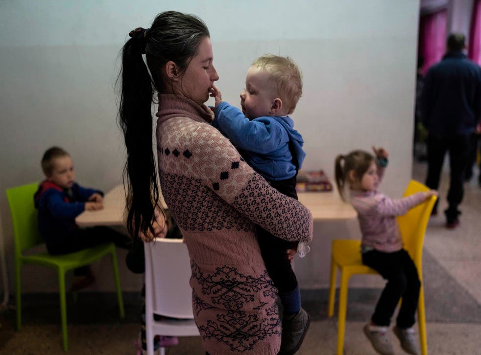 <p>Marta Fedorova, holds her son, Volodymir, in a school being used as a shelter in Dnipro, central Ukraine </s>
