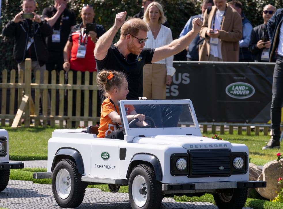 <p>The Duke of Sussex celebrates when arriving first in a mini Land Rover driven by a child when attending the Land Rover Driving Challenge at the Invictus Games</s>