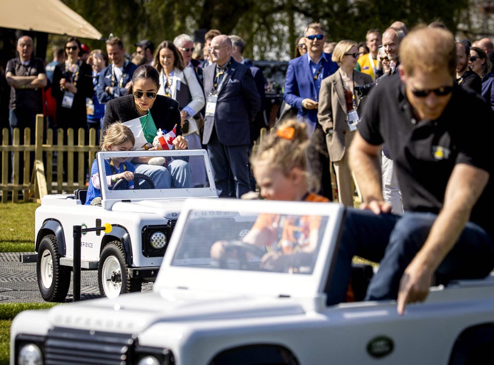 <p>The royal couple look on children ride in toy cars at the Invictus Games</s>
