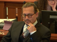 Johnny Depp laughs and covers face during heated cross-examination of psychiatrist
