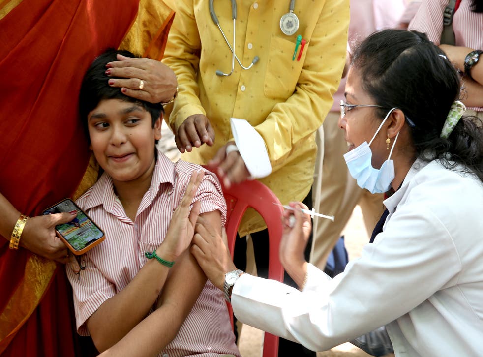 <p>A student reacts as he receives a shot of Covid-19 vaccine during a vaccination drive for children aged 12 to 14 in Bangalore</p>