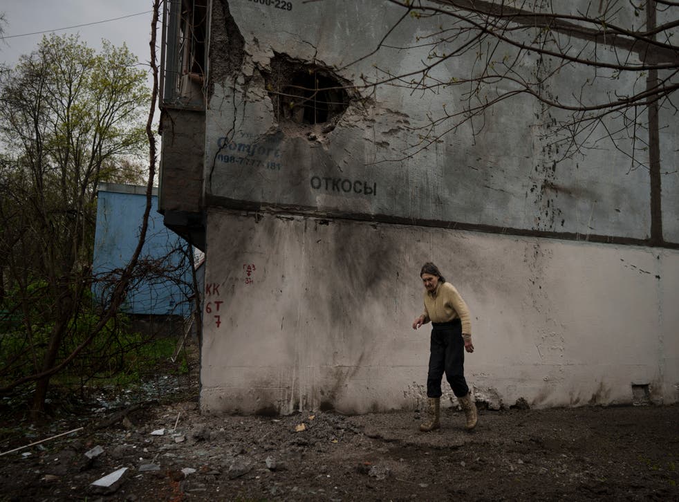 <p>A woman walks next to a damaged building after a Russian bombardment in Kharkiv</s>